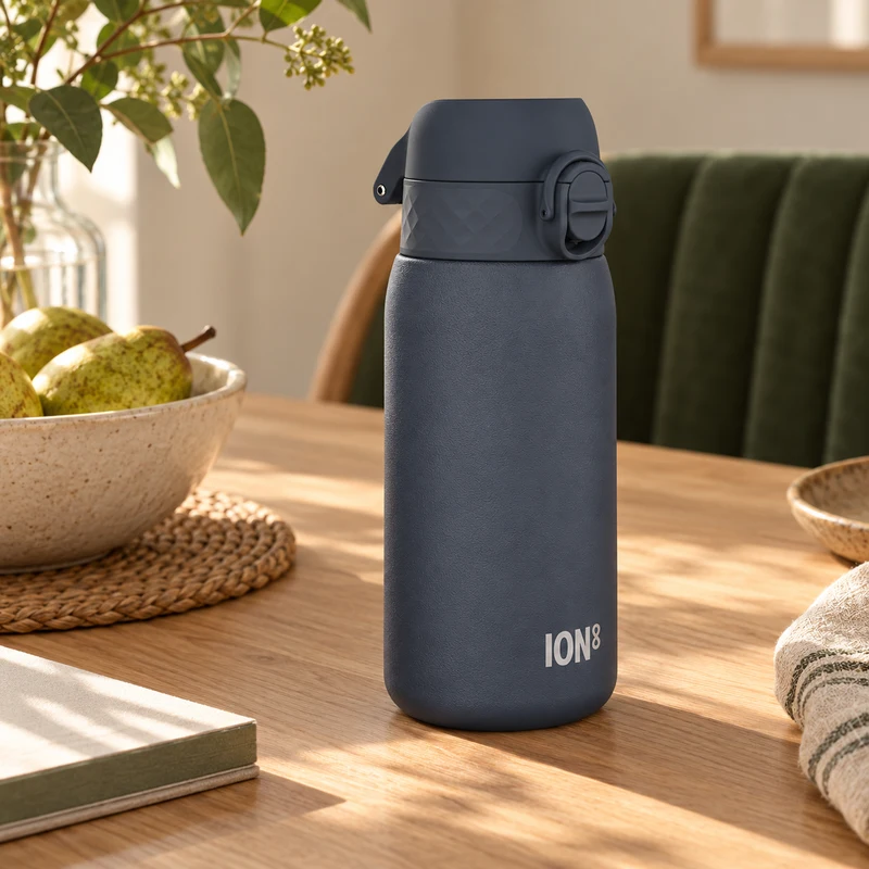 Ash-navy ION8 stainless steel water bottle in warm daylight
